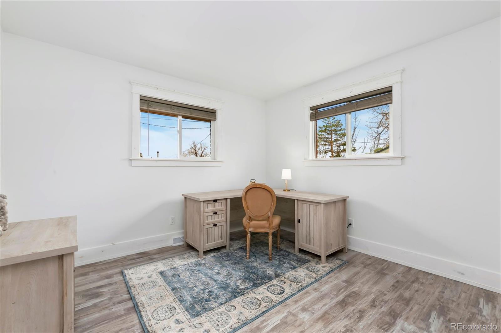 924 Teal Drive Fort Collins, CO 80521 - Photo 19 of 32 a living room with couch and paintings on the wall