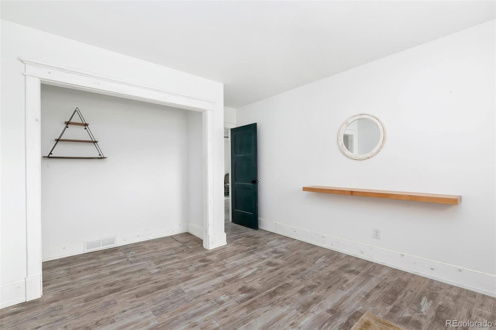 924 Teal Drive Fort Collins, CO 80521 - Photo 21 of 32 a view of an empty room with wooden floor