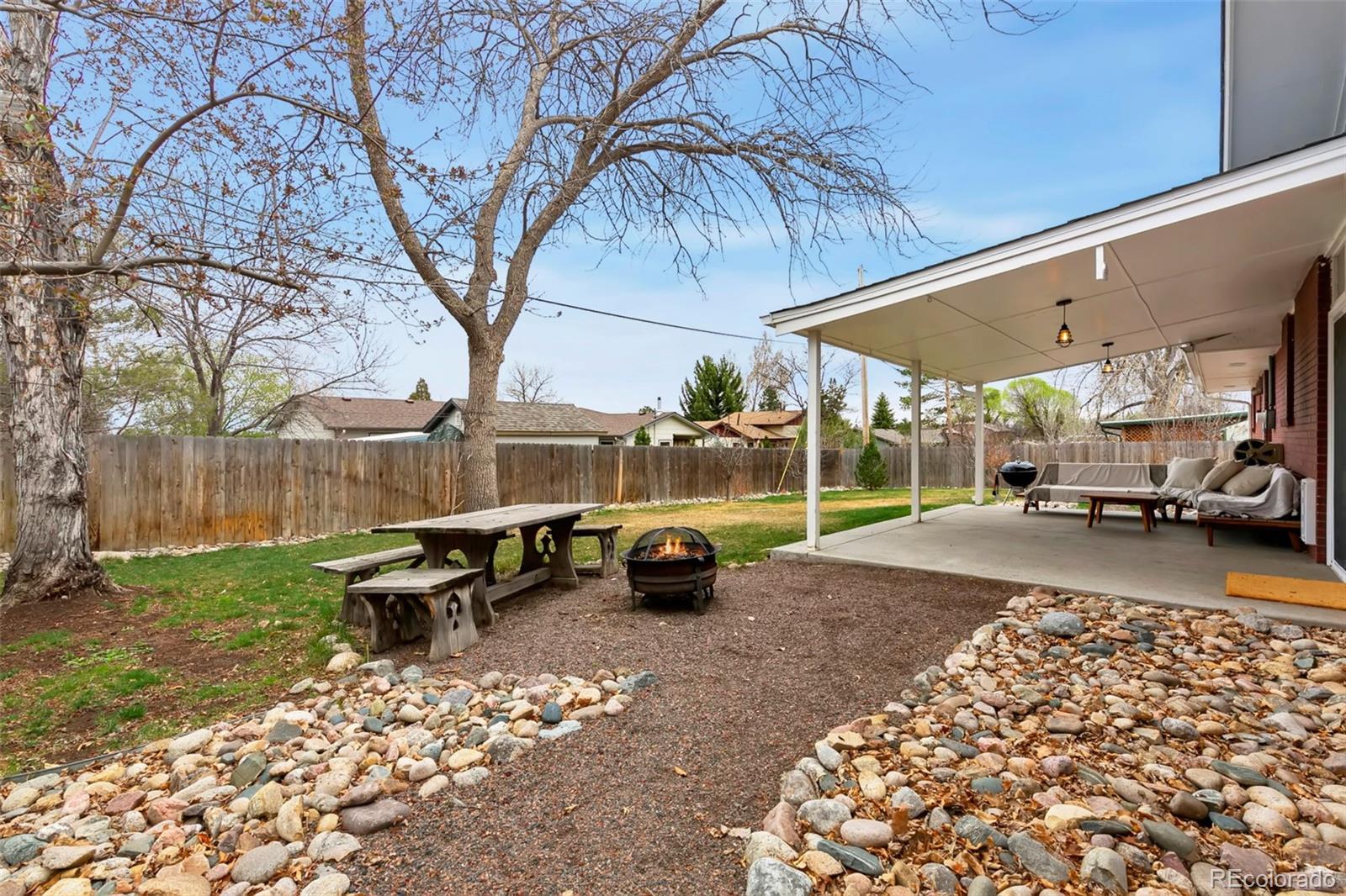 924 Teal Drive Fort Collins, CO 80521 - Photo 25 of 32 a view of a patio with table and chairs and potted plants