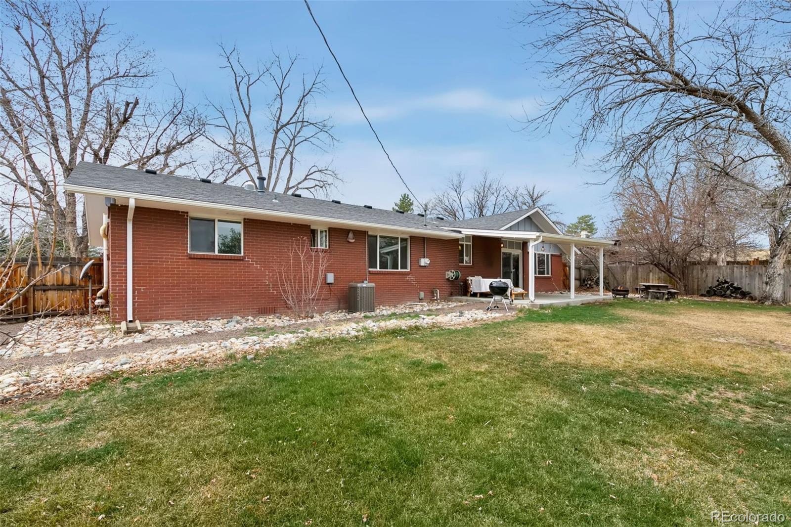 924 Teal Drive Fort Collins, CO 80521 - Photo 27 of 32 a front view of a house with a garden and yard