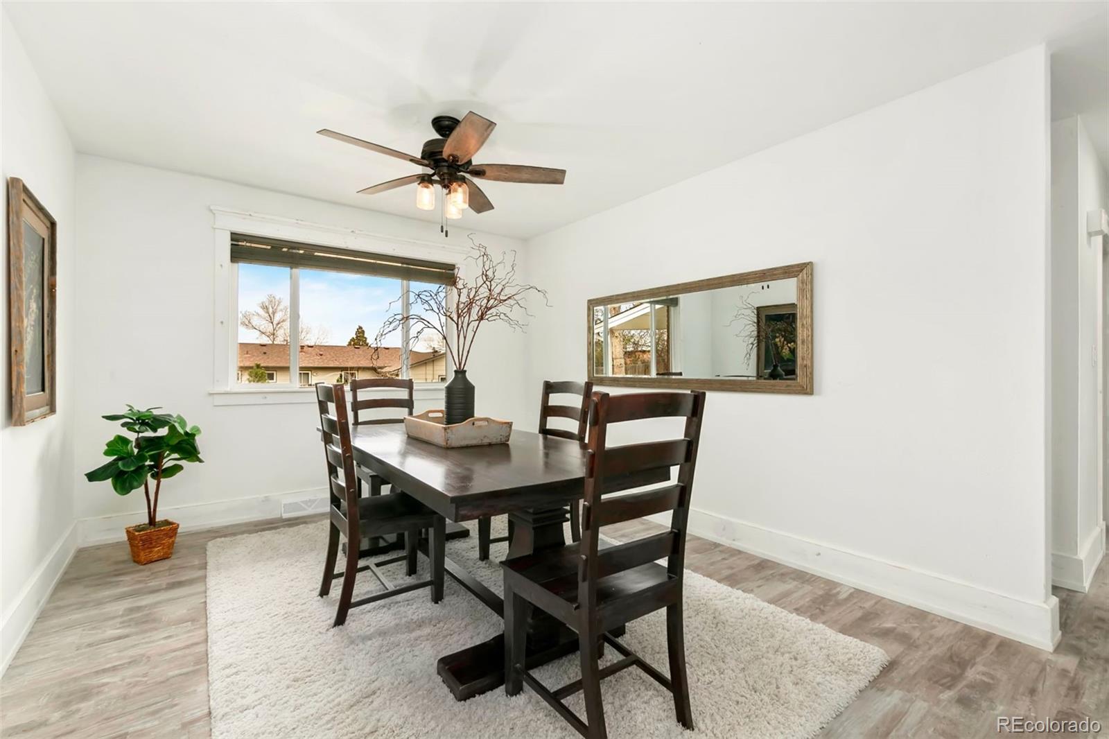 924 Teal Drive Fort Collins, CO 80521 - Photo 9 of 32 a view of a dining room with furniture and a chandelier