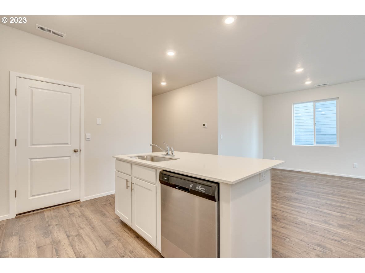 2686 Fenya Street Springfield, OR 97477 - Photo 11 of 20 a kitchen with a stove and white cabinets