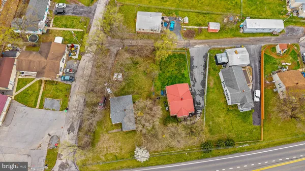 an aerial view of residential house with outdoor space and parking