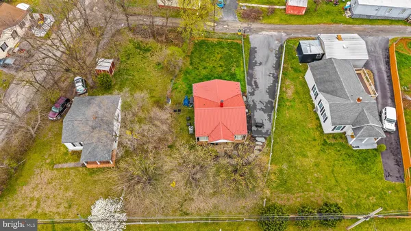 an aerial view of residential houses with yard