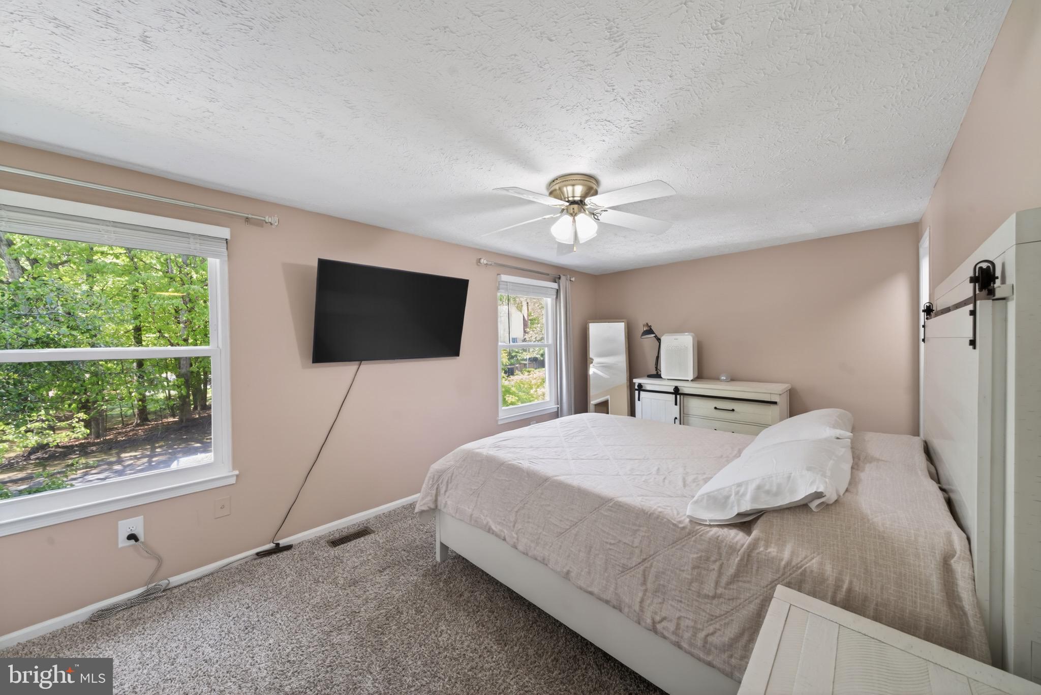 15095 Mill Spring Drive Dumfries, VA 22025 - Photo 12 of 36 a bedroom with a bed tv and a window