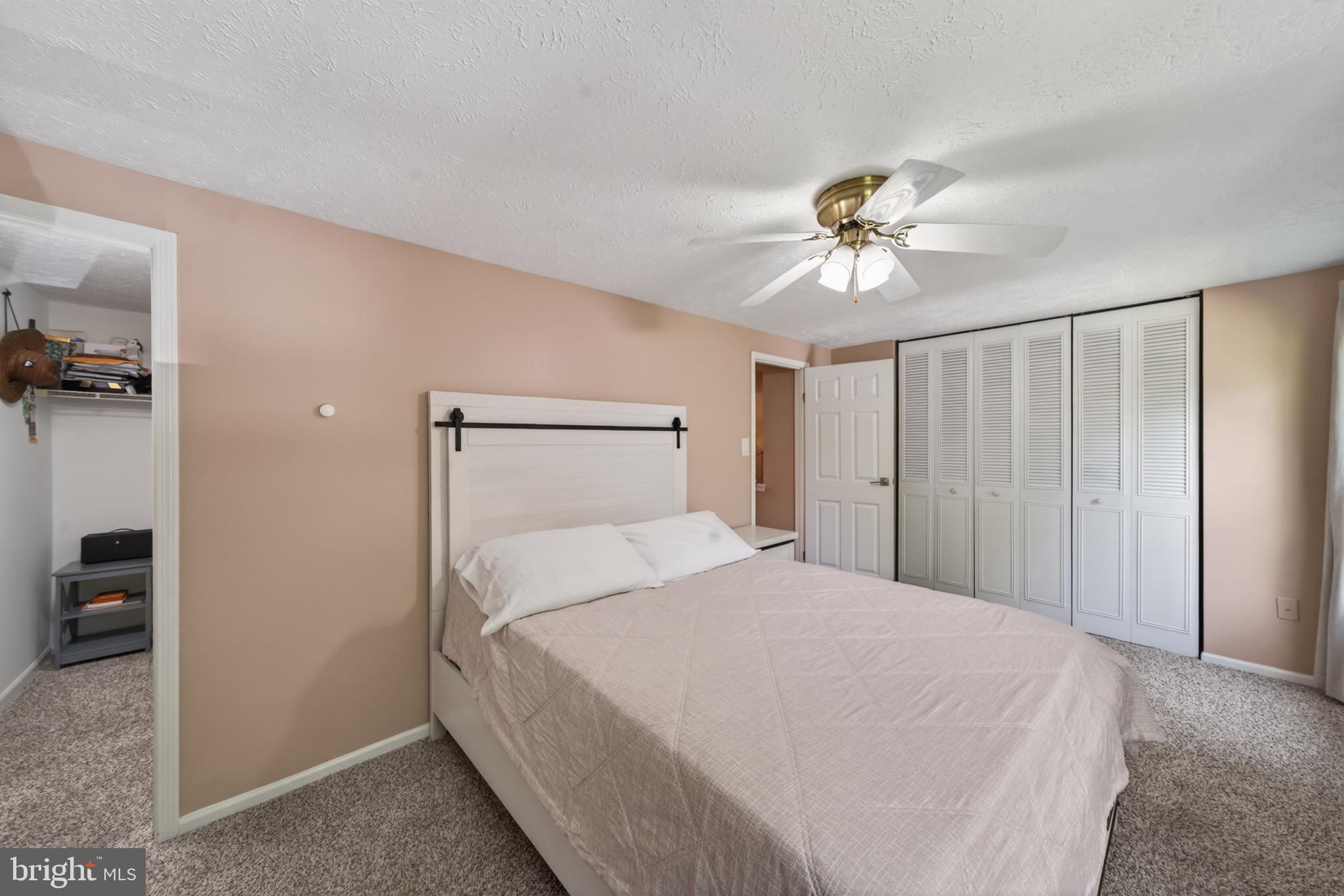 15095 Mill Spring Drive Dumfries, VA 22025 - Photo 13 of 36 a bedroom with a bed and a ceiling fan