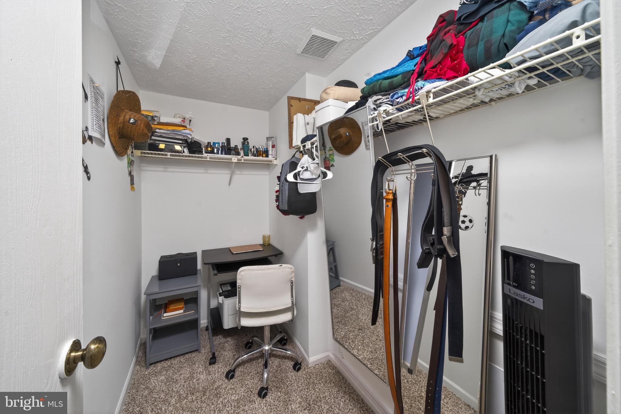 15095 Mill Spring Drive Dumfries, VA 22025 - Photo 14 of 36 a view of walk in closet with clothes and shoes