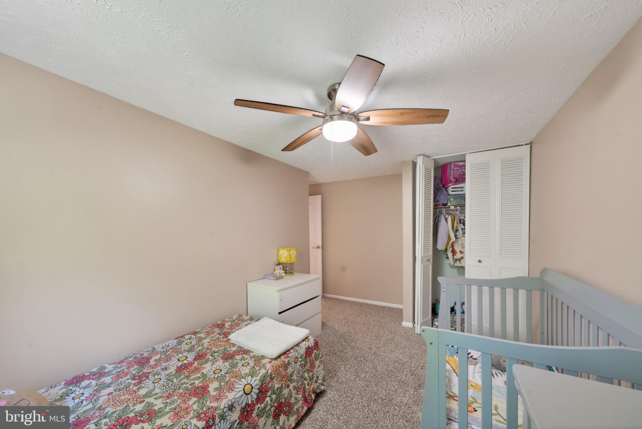 15095 Mill Spring Drive Dumfries, VA 22025 - Photo 17 of 36 a bedroom with a bed and a chandelier