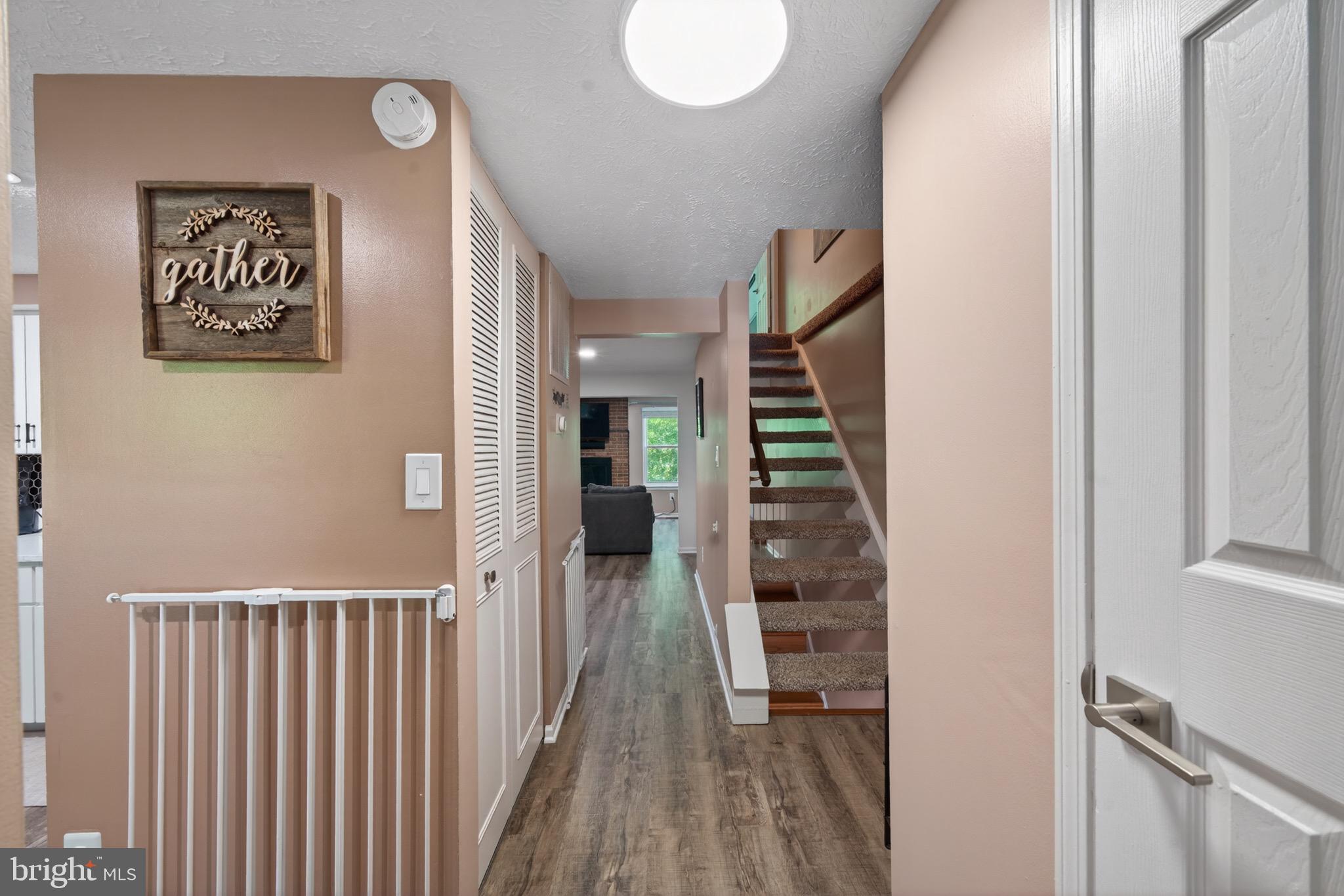 15095 Mill Spring Drive Dumfries, VA 22025 - Photo 6 of 36 a view of a hallway with wooden floor and entryway