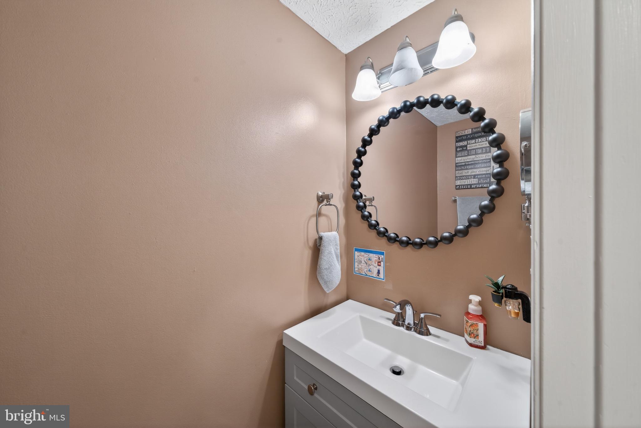 15095 Mill Spring Drive Dumfries, VA 22025 - Photo 7 of 36 a bathroom with a sink and mirror