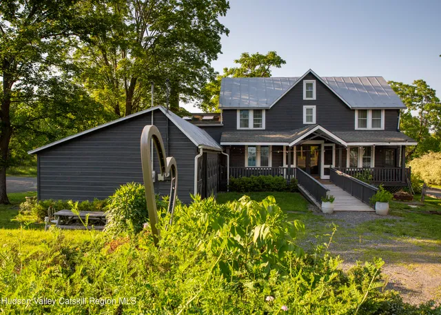 a living room with a fireplace and wooden floor