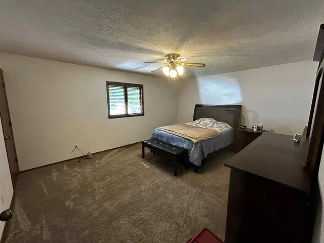 a bedroom with bed and a chandelier