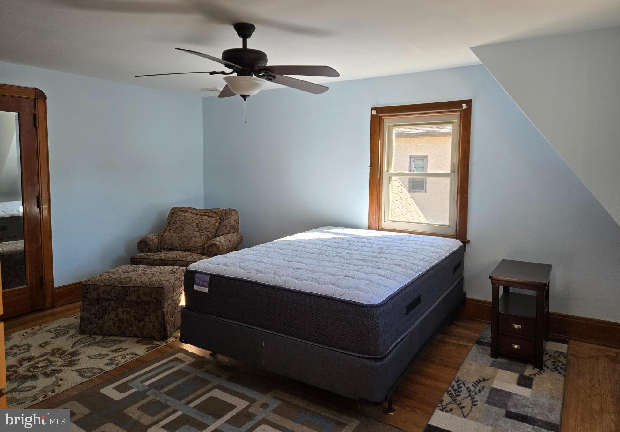 18 North State Street, Unit UPSTAIRS Vineland, NJ 08360 - Photo 2 of 5 a bedroom with a bed and a chandelier