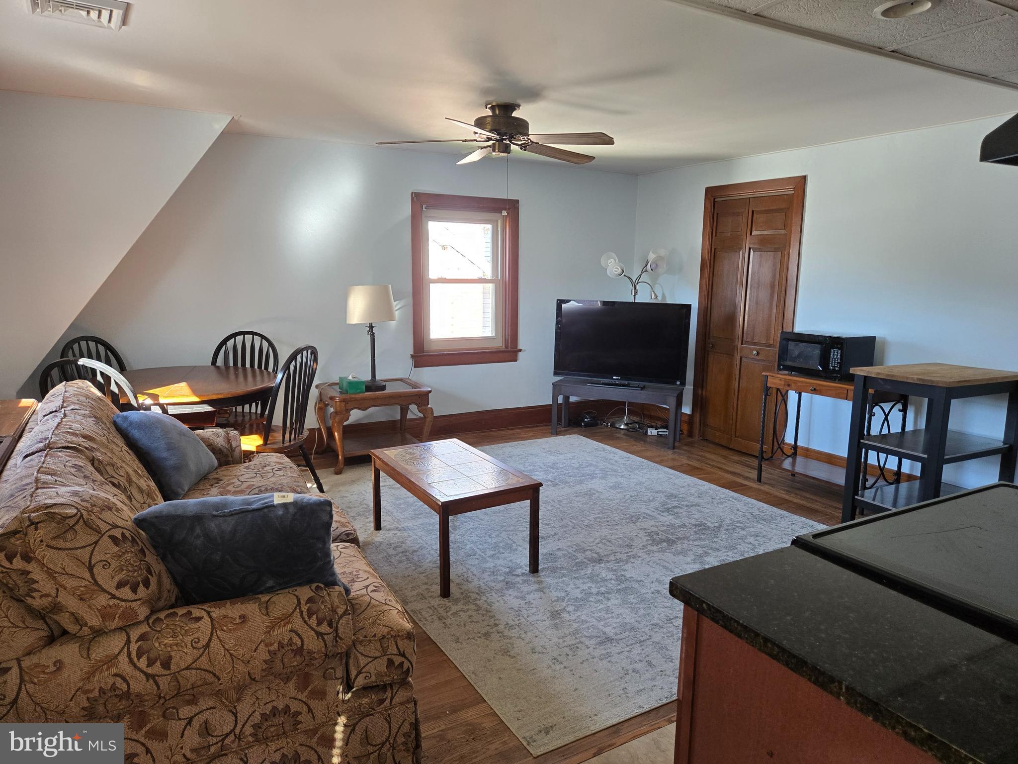 18 North State Street, Unit UPSTAIRS Vineland, NJ 08360 - Photo 5 of 5 a living room with furniture a window and a flat screen tv
