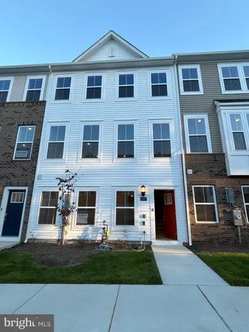 a view of a brick building next to a yard