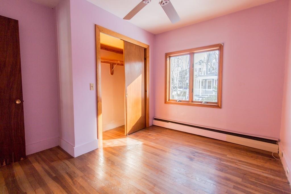 46 Eliot Crescent Brookline, MA 02467 - Photo 12 of 15 an empty room with wooden floor and windows