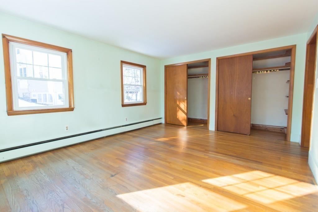 46 Eliot Crescent Brookline, MA 02467 - Photo 14 of 15 a view of an empty room with wooden floor and a window
