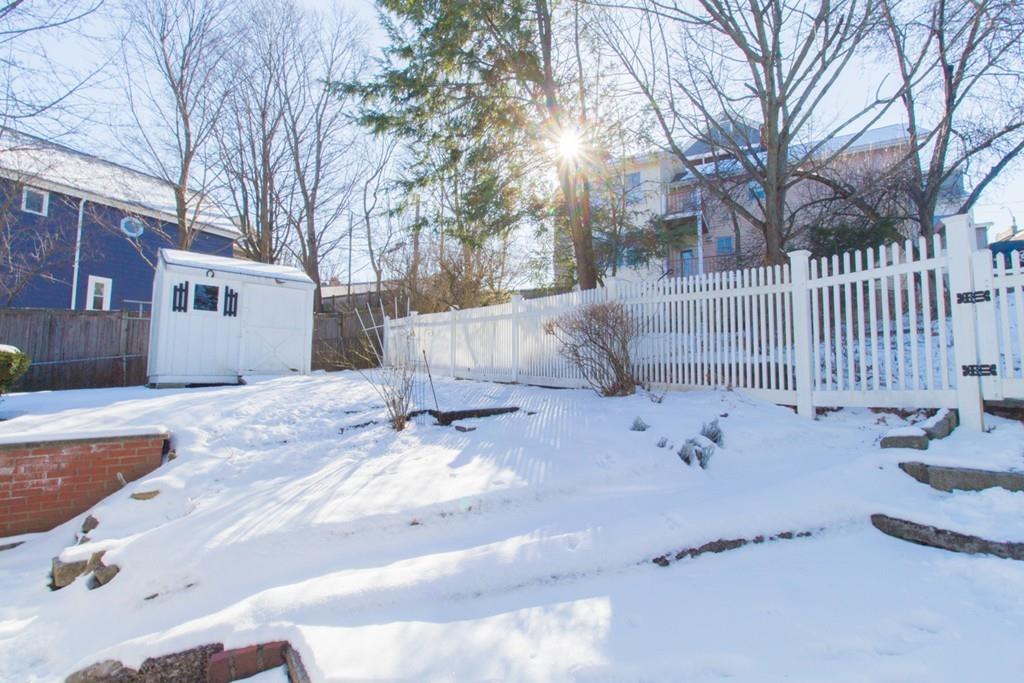 46 Eliot Crescent Brookline, MA 02467 - Photo 15 of 15 a view of white house with a snow covered by side of a road