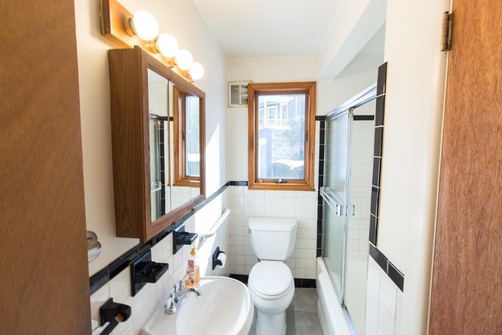 46 Eliot Crescent Brookline, MA 02467 - Photo 6 of 15 a bathroom with a toilet a sink and a large mirror
