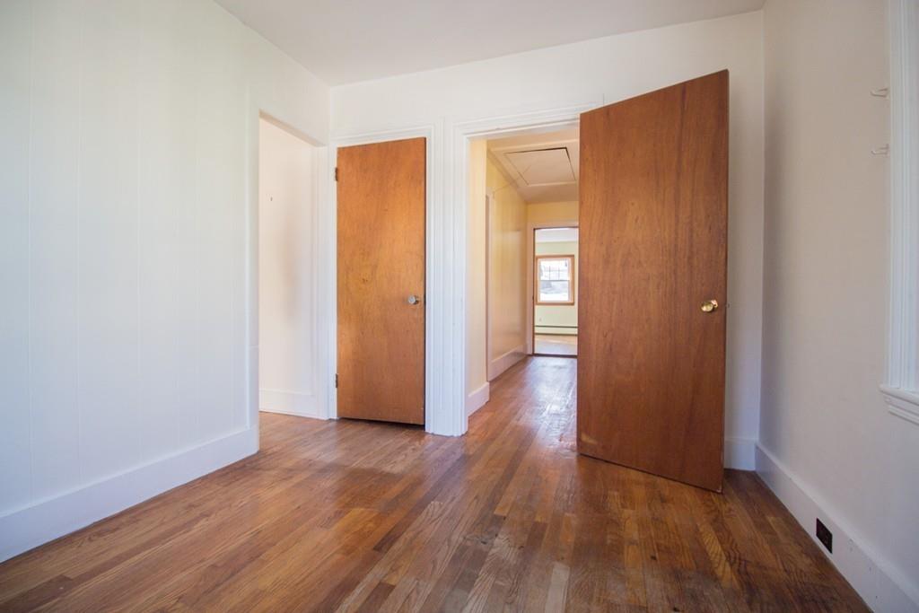 46 Eliot Crescent Brookline, MA 02467 - Photo 8 of 15 an empty room with wooden floor and closet