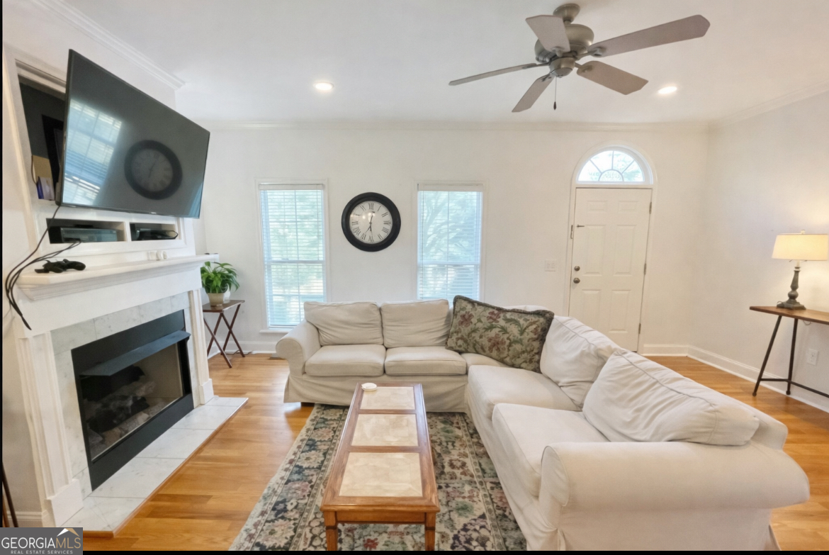 376 Providence Boulevard Macon, GA 31210 - Photo 2 of 26 a living room with furniture a clock and a fireplace