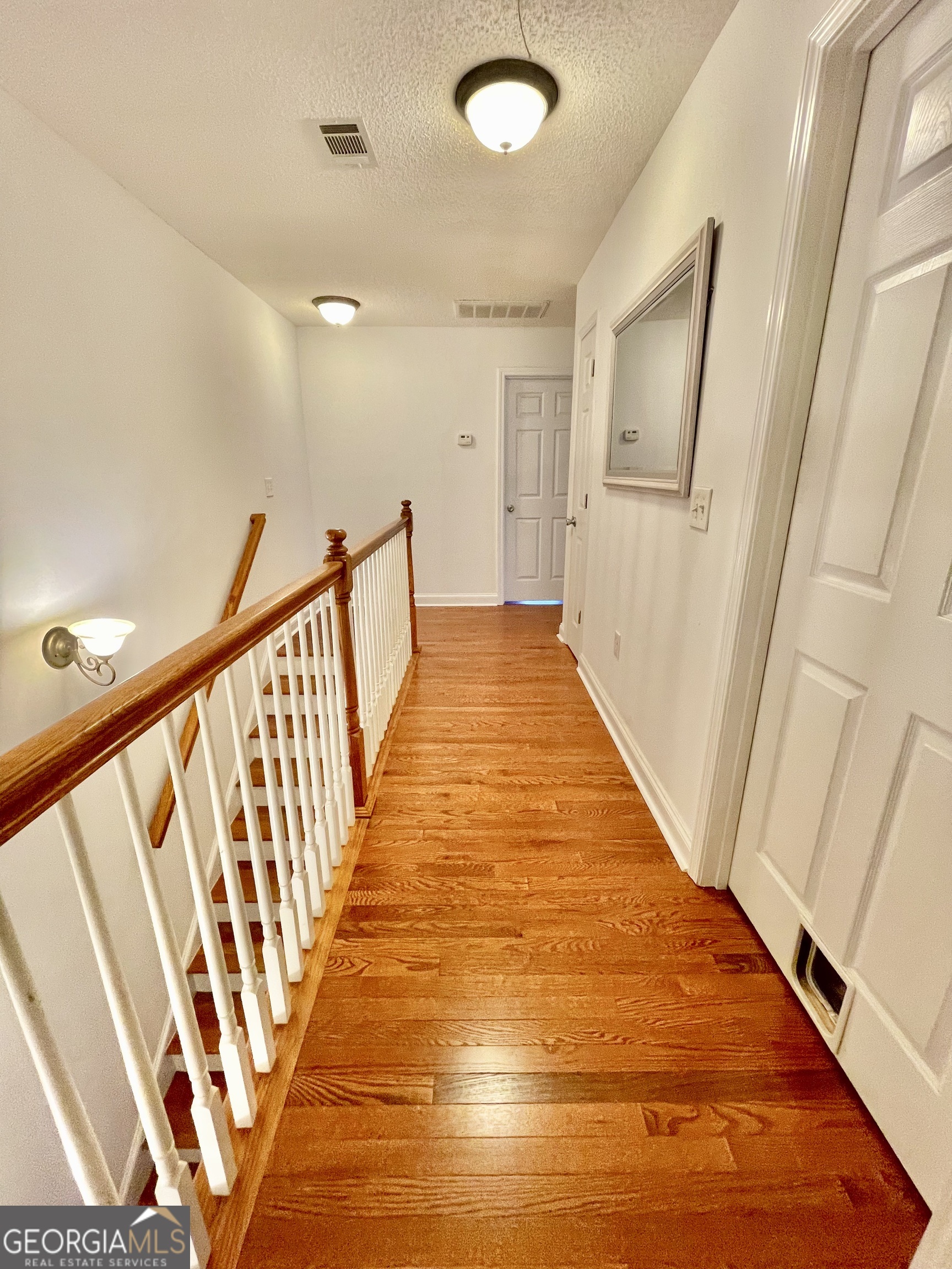 376 Providence Boulevard Macon, GA 31210 - Photo 10 of 26 a view of a hallway with wooden floor and staircase