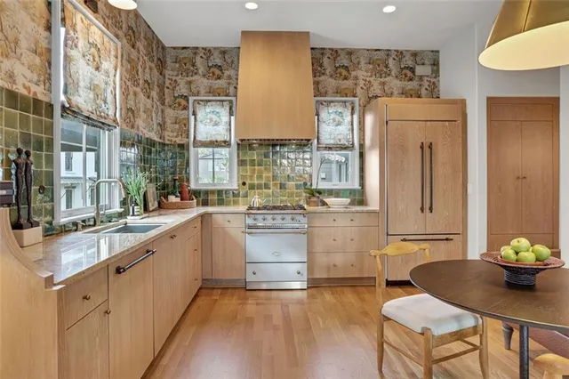 a stove top oven sitting inside of a kitchen