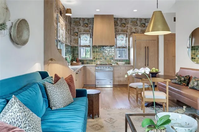a living room with furniture a table and a chandelier