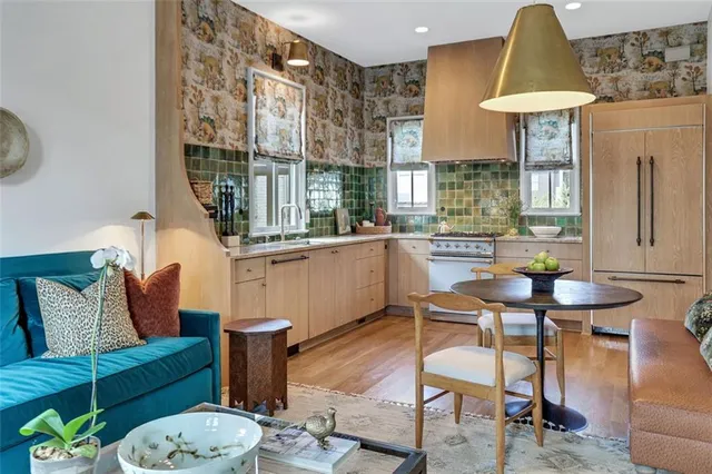 a kitchen with kitchen island granite countertop a stove and a sink