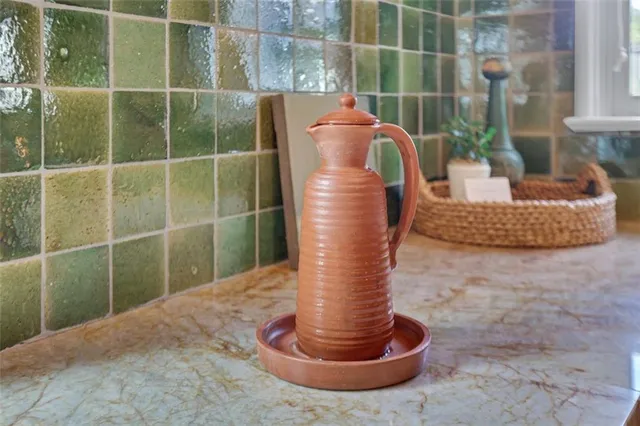 a open kitchen with granite countertop a stove and a white refrigerator