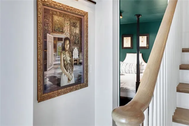 a bedroom with a bed lamps and a large mirror