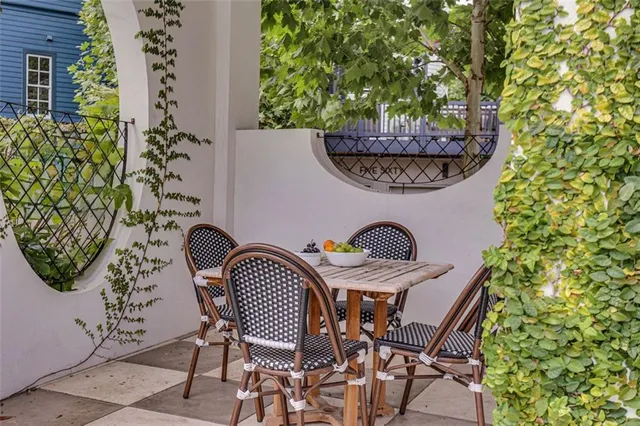 a view of a small house with potted plants