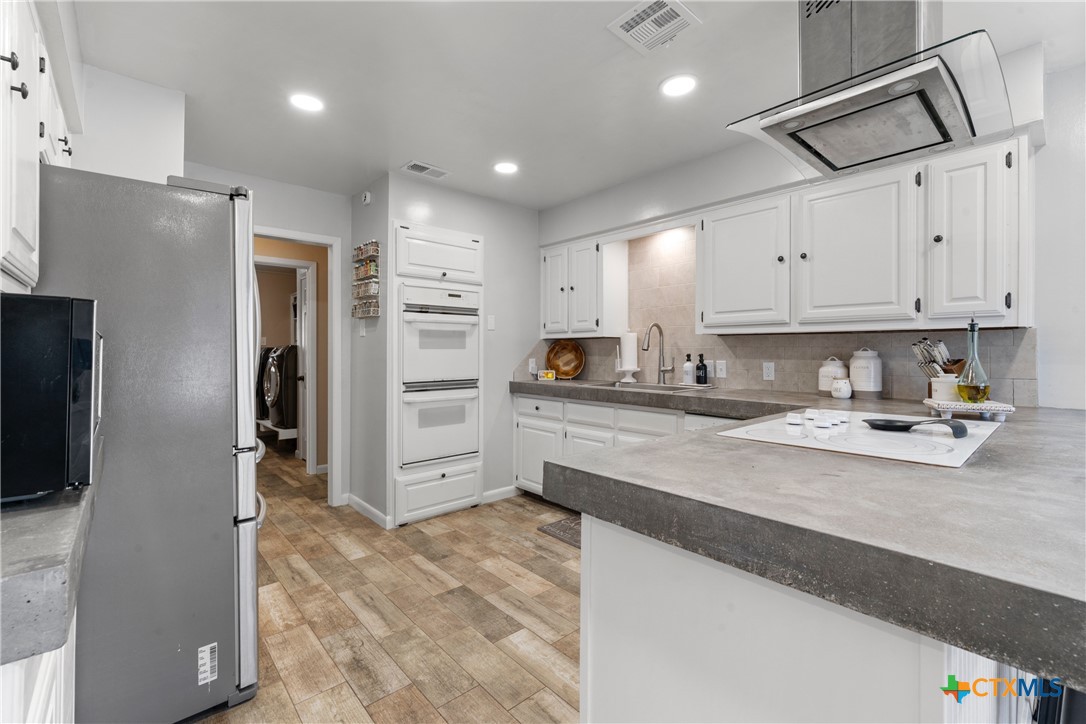 162 High Ridge Drive Bruceville, TX 76630 - Photo 11 of 35 a kitchen with refrigerator and cabinets