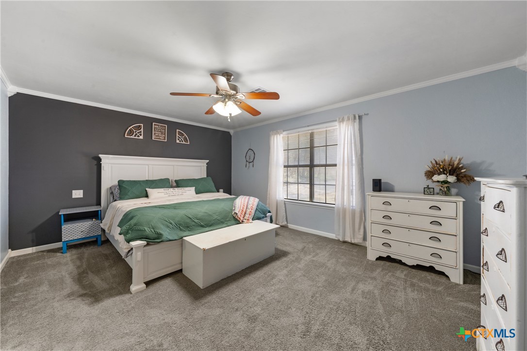 162 High Ridge Drive Bruceville, TX 76630 - Photo 14 of 35 a bedroom with a bed and a chandelier