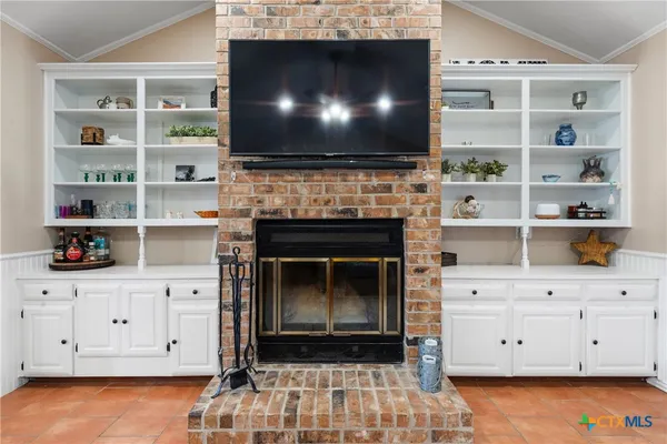 a living room with a fireplace and a flat screen tv