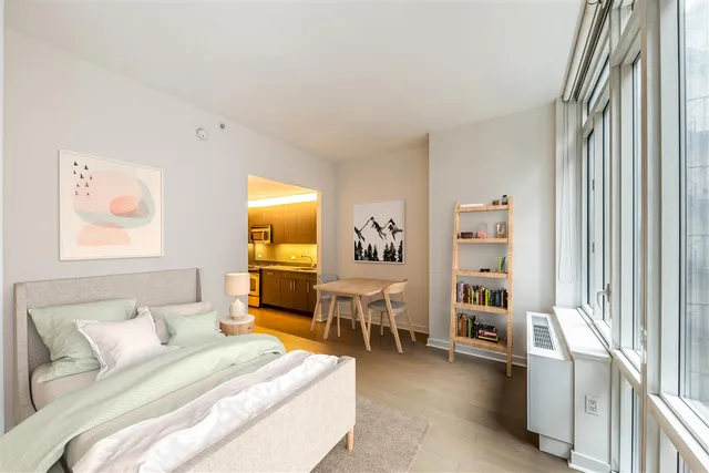 a bedroom with furniture and a flat screen tv