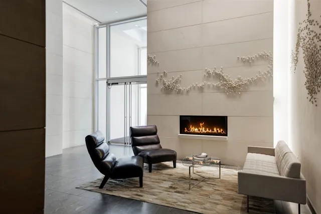 a living room with furniture a large window and a flat screen tv