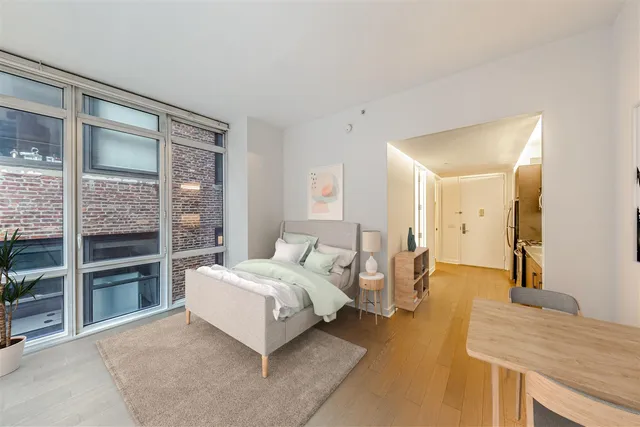 a spacious bedroom with a bed and a table