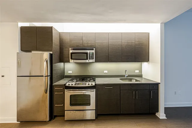 a kitchen with a sink a stove and refrigerator