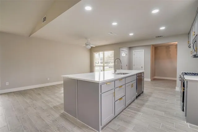 a kitchen with a sink stove and microwave