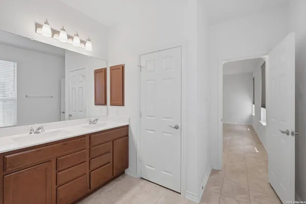 a spacious bathroom with a double vanity sink and mirror