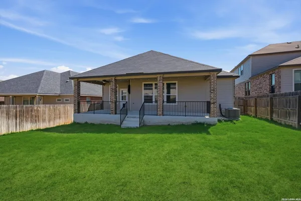 a view of a house with a yard and a porch