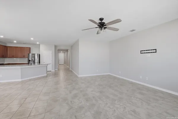 a view of a kitchen with a sink and a refrigerator