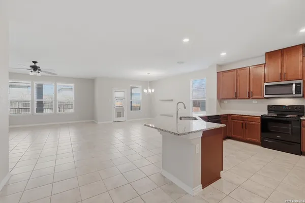 a kitchen with stainless steel appliances granite countertop a sink stove and cabinets