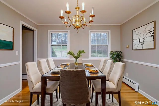 a view of a dining room with furniture window and wooden floor