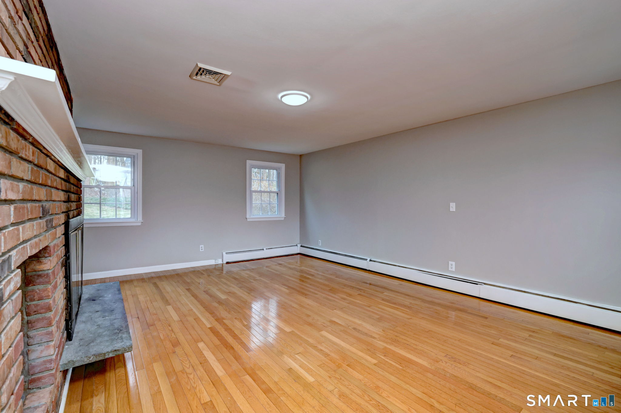 25 Shelter Rock Road Trumbull, CT 06611 - Photo 14 of 37 a view of an empty room with wooden floor and a window