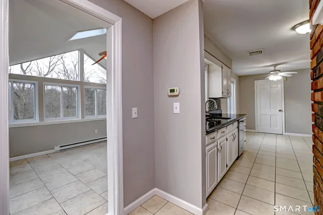 a kitchen with granite countertop a refrigerator and a sink