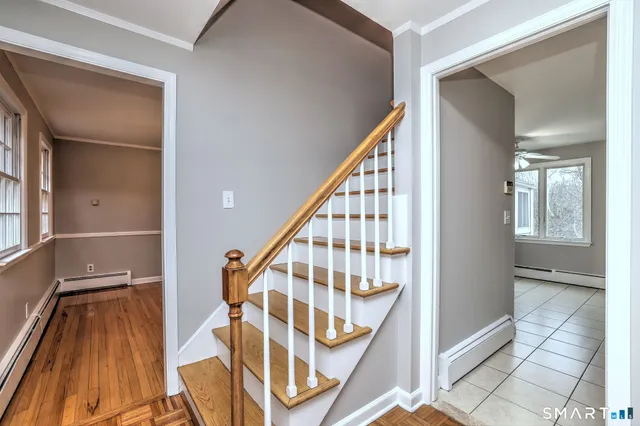 a view of staircase with white walls and a next to a window