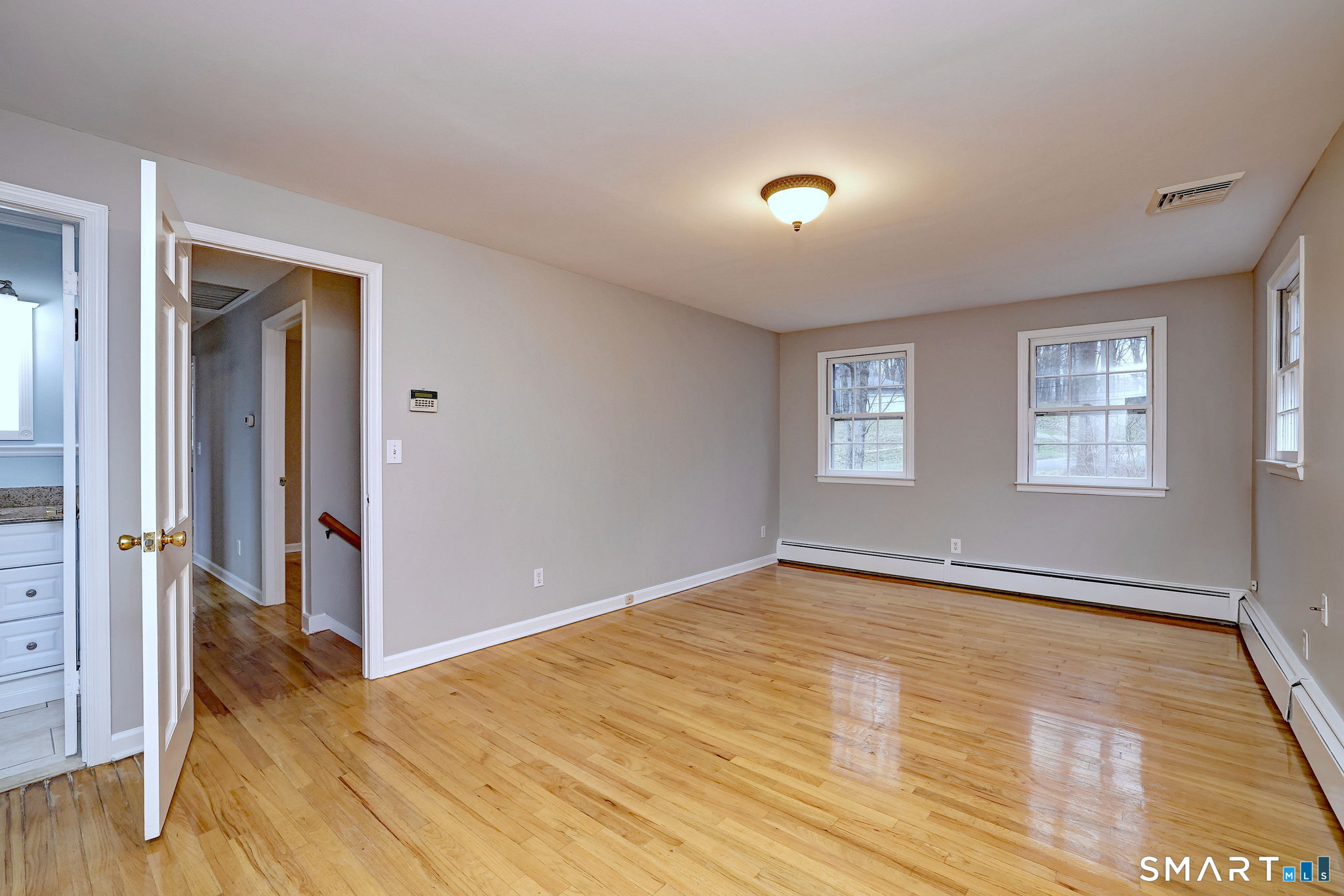 25 Shelter Rock Road Trumbull, CT 06611 - Photo 23 of 37 an empty room with wooden floor and windows