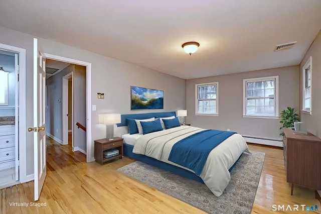 a spacious bedroom with a bed and a couch